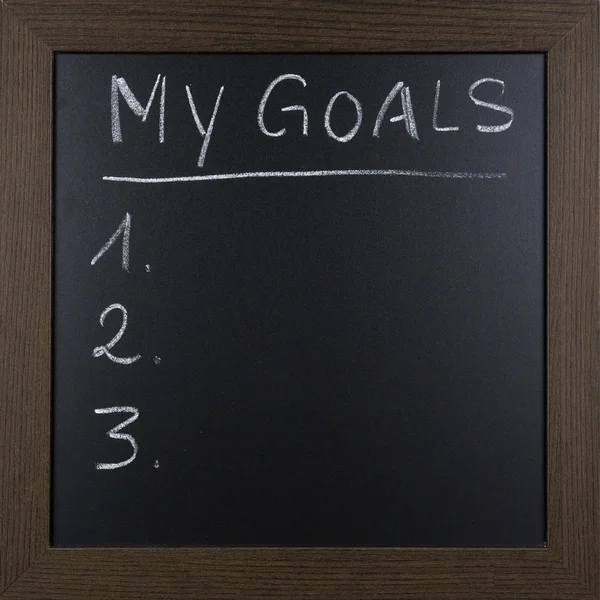 Handwritten list of MY GOALS on blackboard.