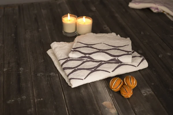 Folded Towel and Napkin with Black Concave Line Design