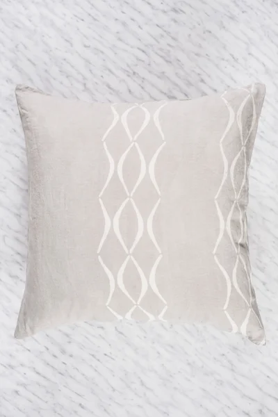 Close Up of Square Gray Throw Pillow Flat on Marble