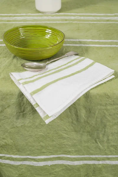 Spoon on Folded White Napkin with Green Stripes