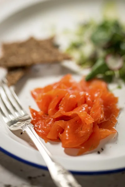 Close up of smoked trout shavings with fork