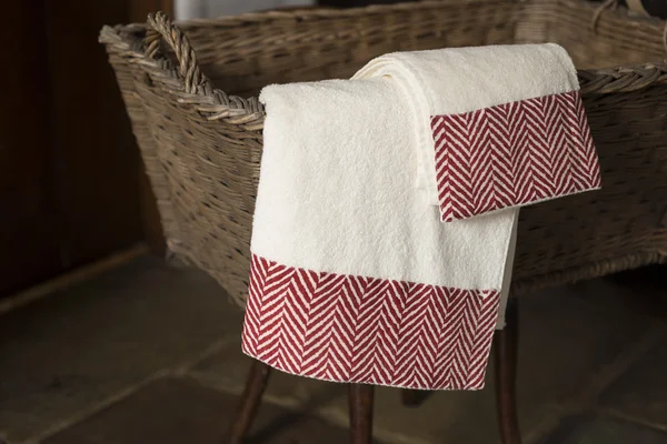 Pair of Towels Hanging From Basket on Wooden Stool