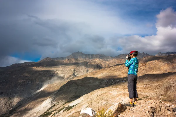 Tourist with camera and mountains