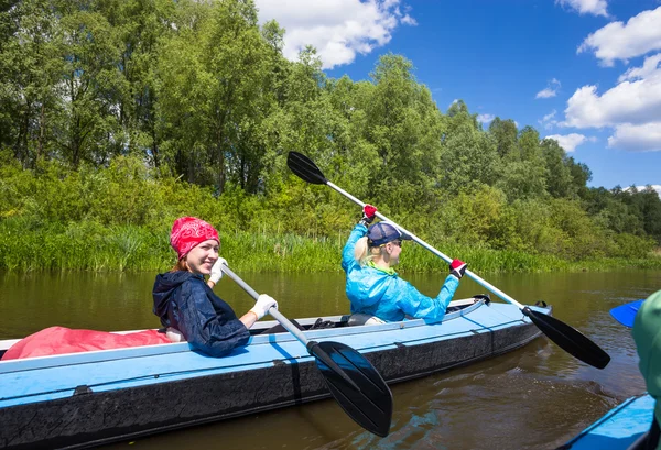 Young people kayaking on river