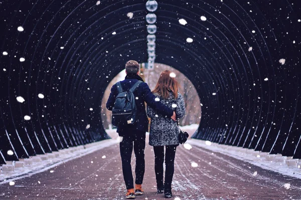 Couple walking on alley in winter park
