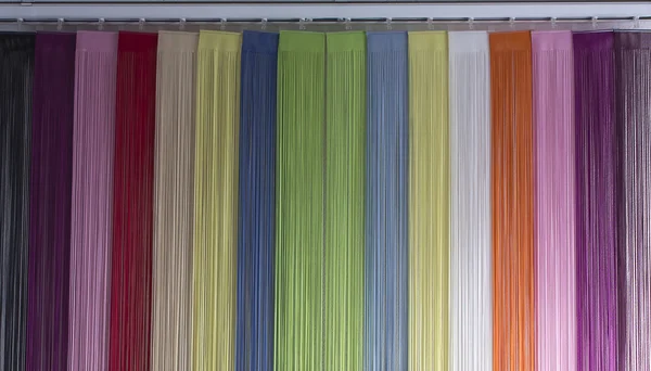 Blinds colored material from a rope on the door