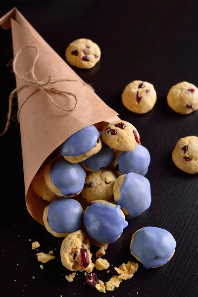 Cottage cheese cookies with cranberries in the blue glaze