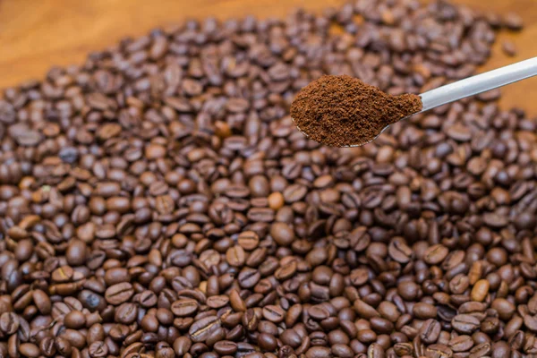 Coffee beans and metal spoon