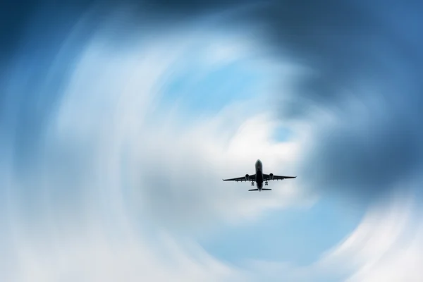 Airplane in the dark skies before storm, Abstract.