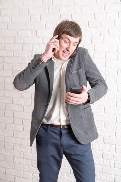 Screaming mad man with several phones