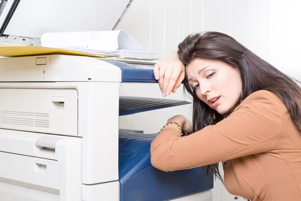 Sad unhappy woman in office with copier printer