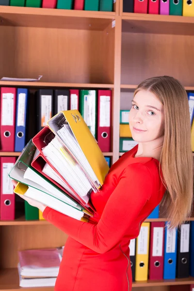 Attractive smiling woman with stack of folders