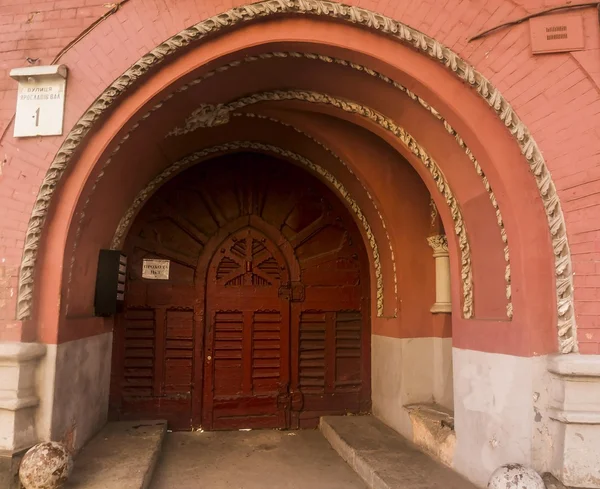 Building with arch and old wooden door