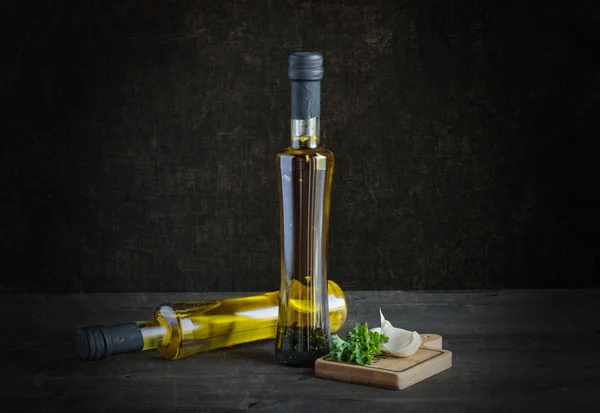 Olive oil and spices on a dark background