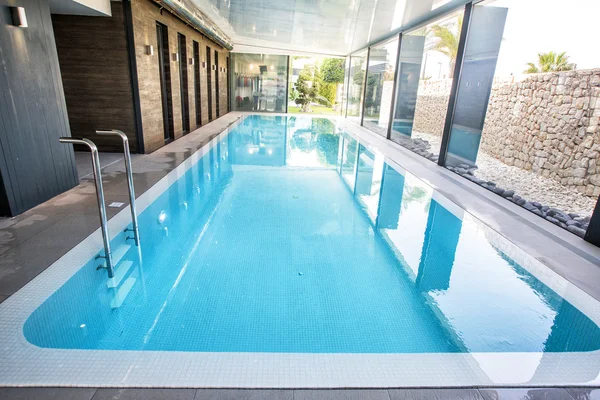 Empty interior swimming pool with relaxation area.