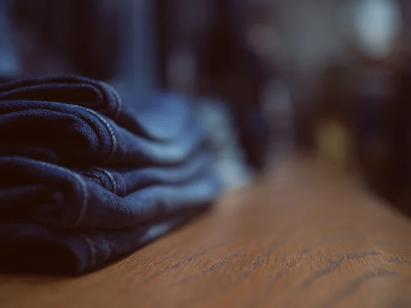 Jeans fashion store on a shelf. Neatly folded clothes. Concept o