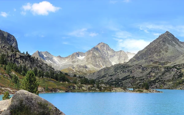 Beautiful mountain landscape blue sky mountain lake. Snowy sunny mountain landscape.