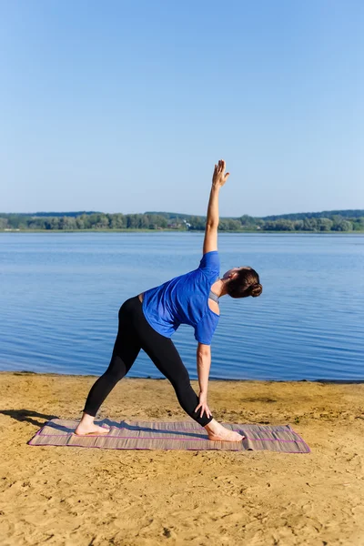 Woman doing yoga triangle pose