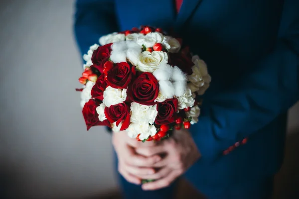 Bridal bouquet of red roses and cotton