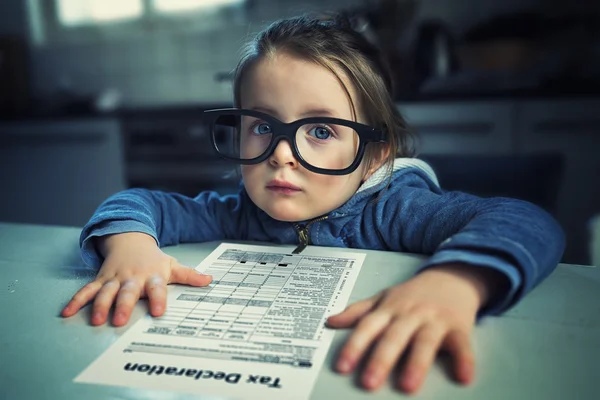 Little smart girl with tax declaration