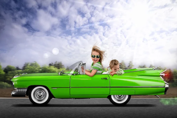 Little girls driving retro car