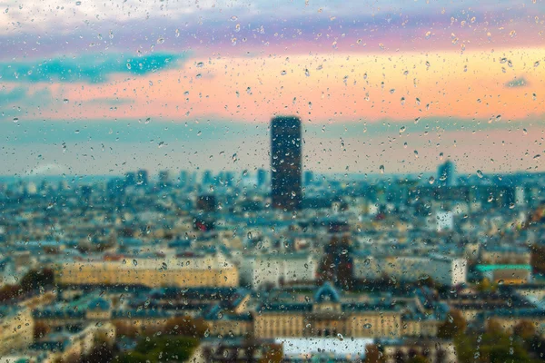 Abstract blurry background with water drops: view through the window Paris by night France