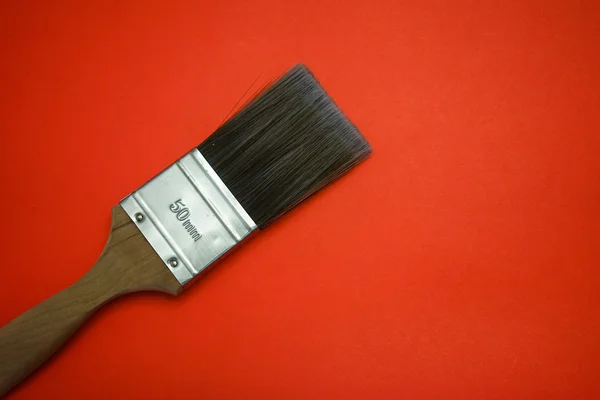 Paint brush in red background