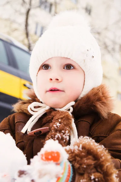 Little girl play with snow in winter