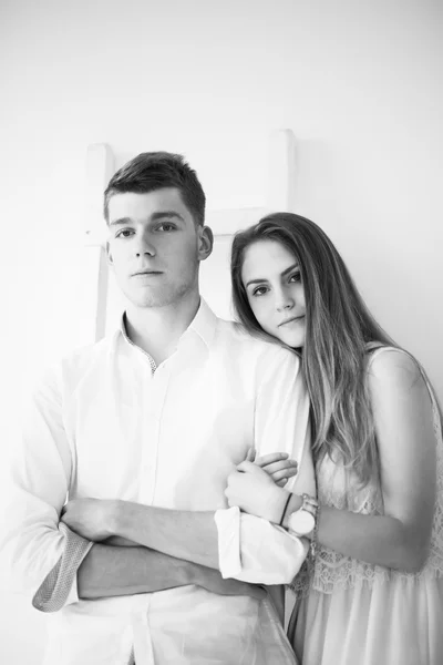 Happy young couple standing together. Black and white