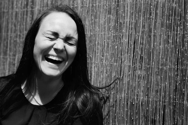 A beautiful young girl laughing. Black and white