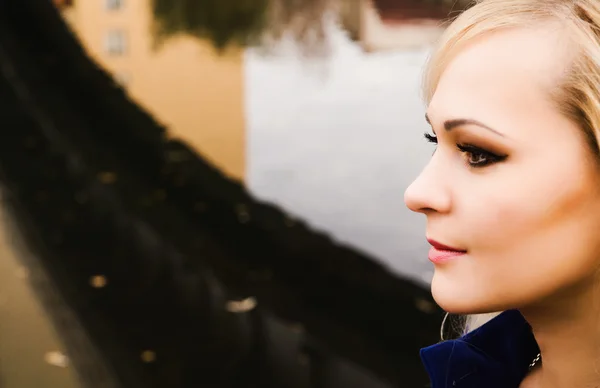 A close up of a woman sitting by river