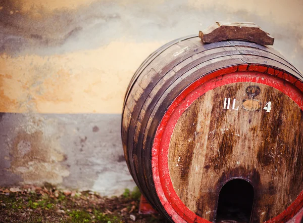 Wine barrel against a stone wall