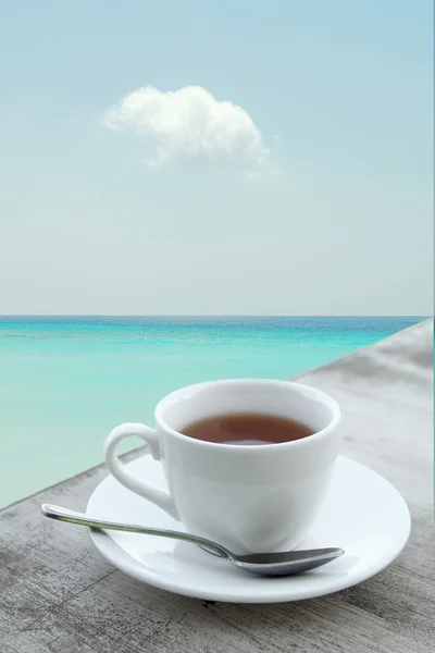 Cup of coffee in front of the sea