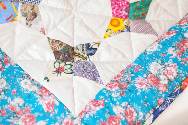 Patchwork quilt. Part of patchwork quilt as background. Flower p
