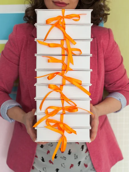 White gift boxes on a white wooden background. White gift boxes.