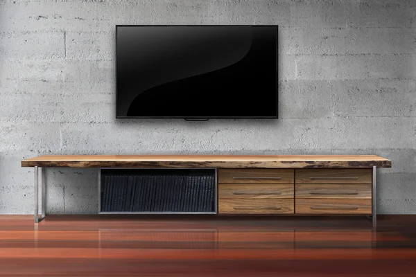 Led tv on concrete wall with wooden table living room