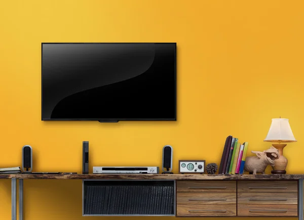 Led tv wooden table with yellow wall in livingroom