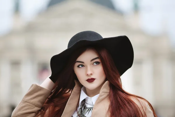 Close up portrait of young beautiful lady wearing stylish classic clothes posing on the street. Girl looking aside. Plus size model. Female fashion concept. Toned
