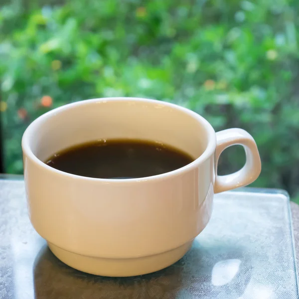 The close up of cup of black coffee in the ceramic coffee cup