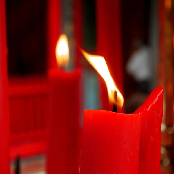 Flame on red candle at Chinese temple