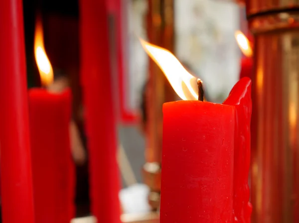 Flame on red candle at Chinese temple