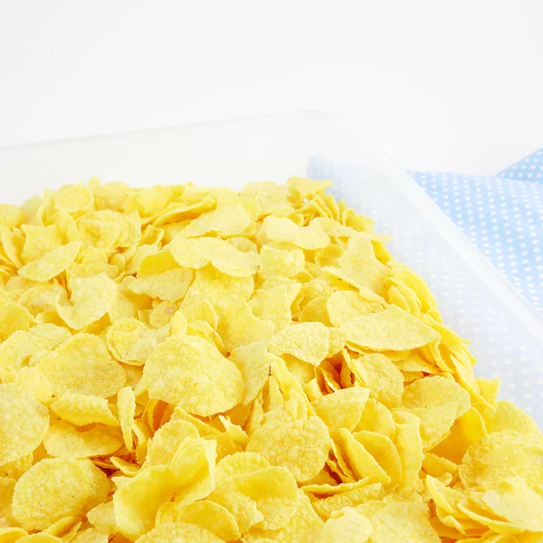 The tasty golden corn flakes in plastic container box