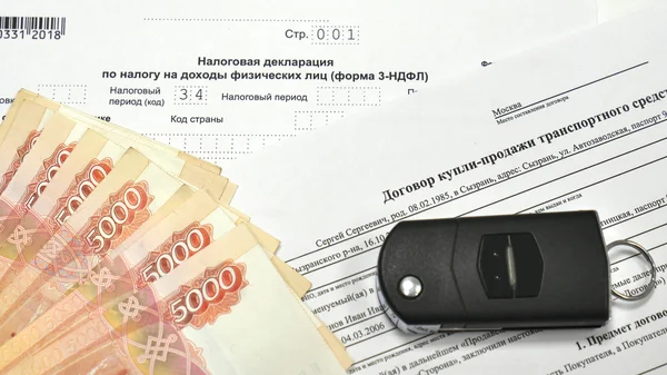 Tax Declaration and Contract of sale of the car. Keychain, car keys and a wad of money