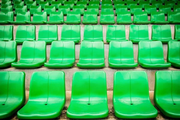 Plastic green seats on football stadium