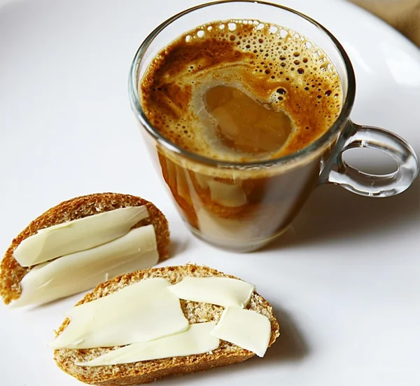 Coffee and bread slices with butter
