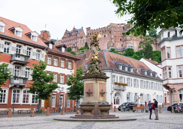 June 12, 2016- Heidelberg, Germany: Virgin Mary or Madonna sculpture standing at Center of Kornmarkt in Heidelberg, Germany. At the back of statue is Heidelberg Castle.