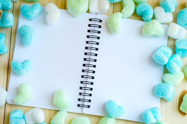 Blue green hearts and blank notebook in soft tone