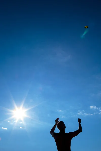 Silhouette of man with kite