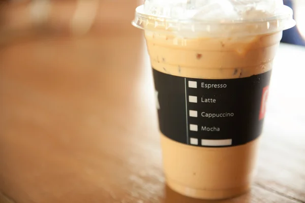Menu on ice coffee cup in shop background