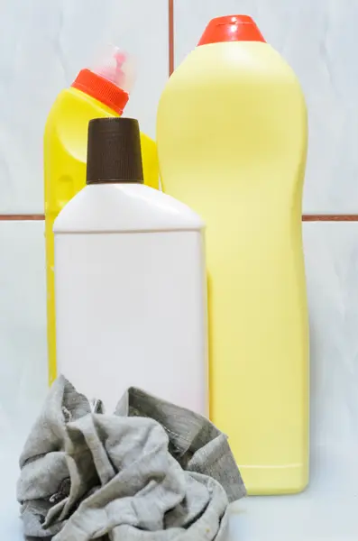 A cleaning cloth and three bottles with cleaning fluid